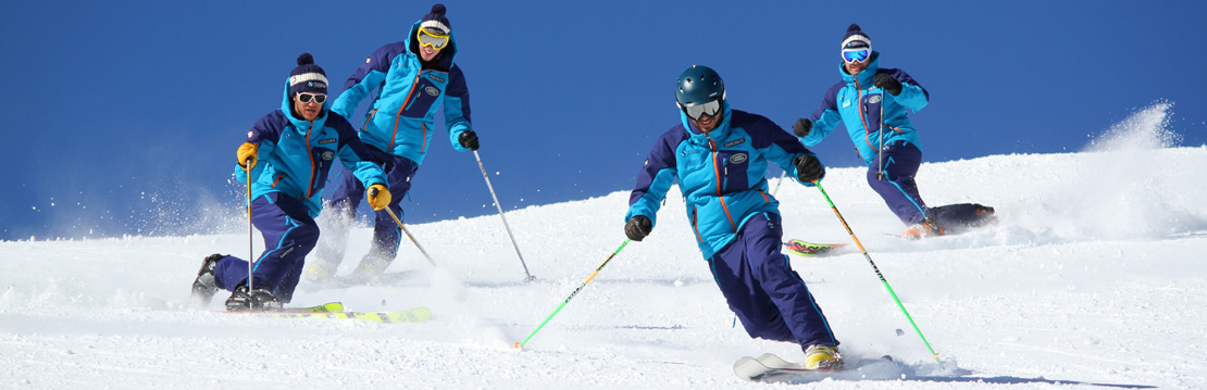 Four ski instructors