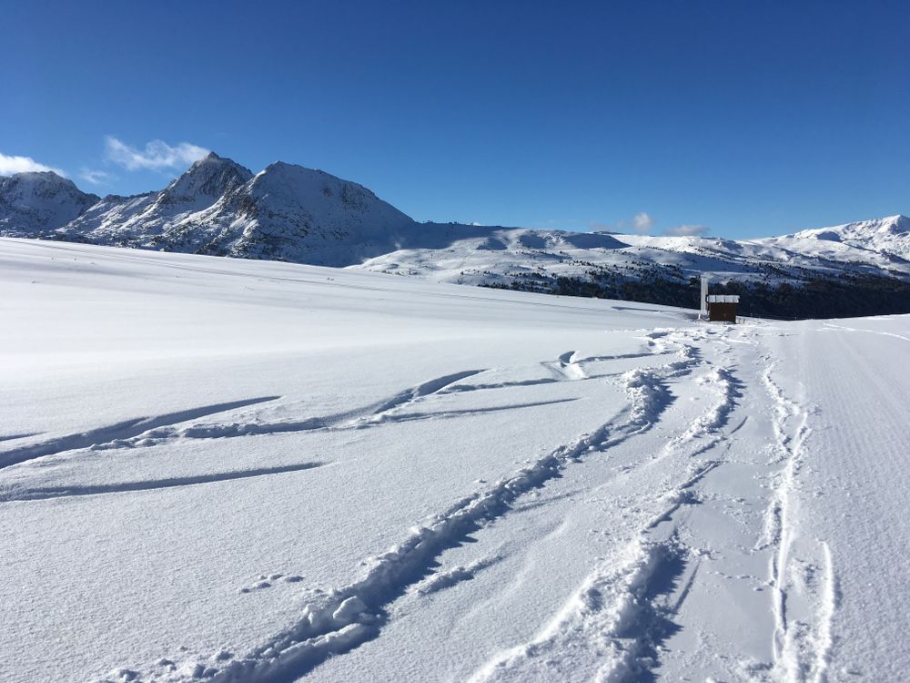 Fresh tracks on a beautiful bluebird powder day in Grau Roig